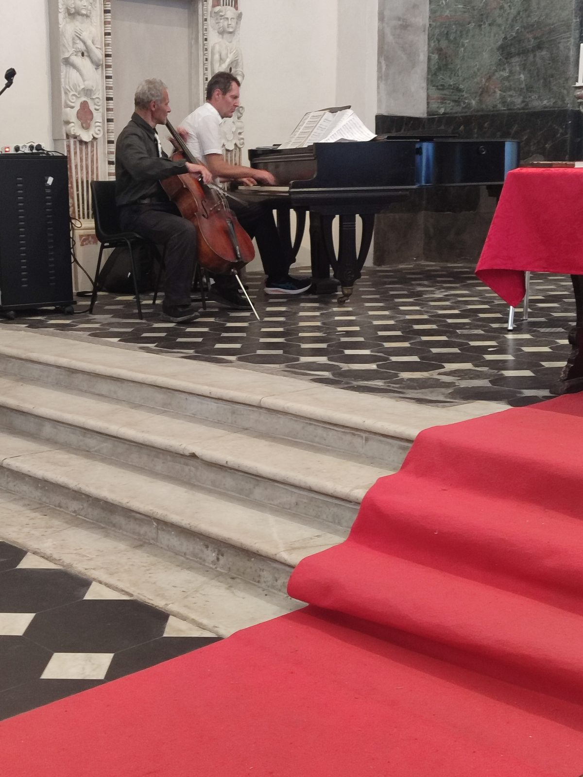 Cellist and pianist on the red-carpeted chancel